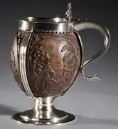 17th-century tankard with hinged lid, and 3 tropical scenes. Carving probably Dutch, the silver mounts probably English